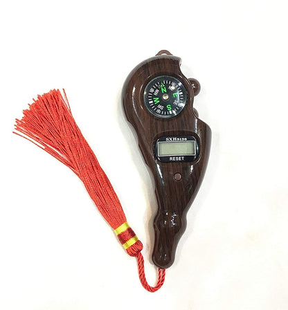 Wooden whistle with digital display and red tassel on a white background